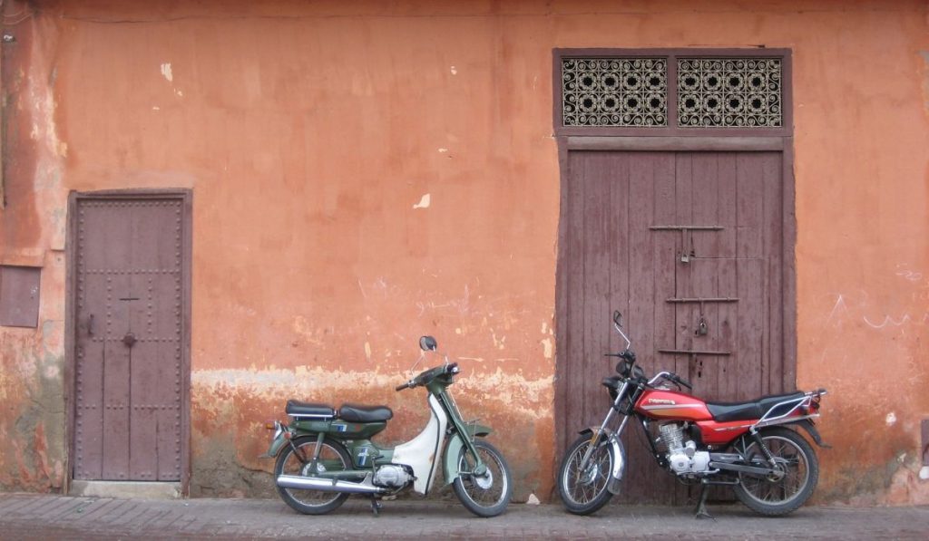 2 motorcycles parked outside the building