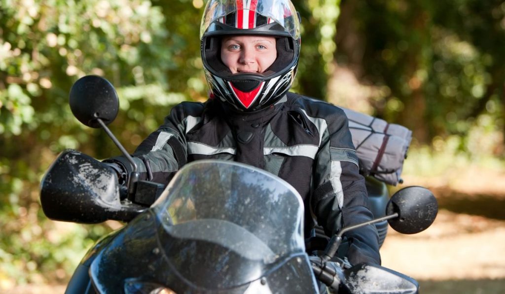 girl riding a motorcycle with helmet