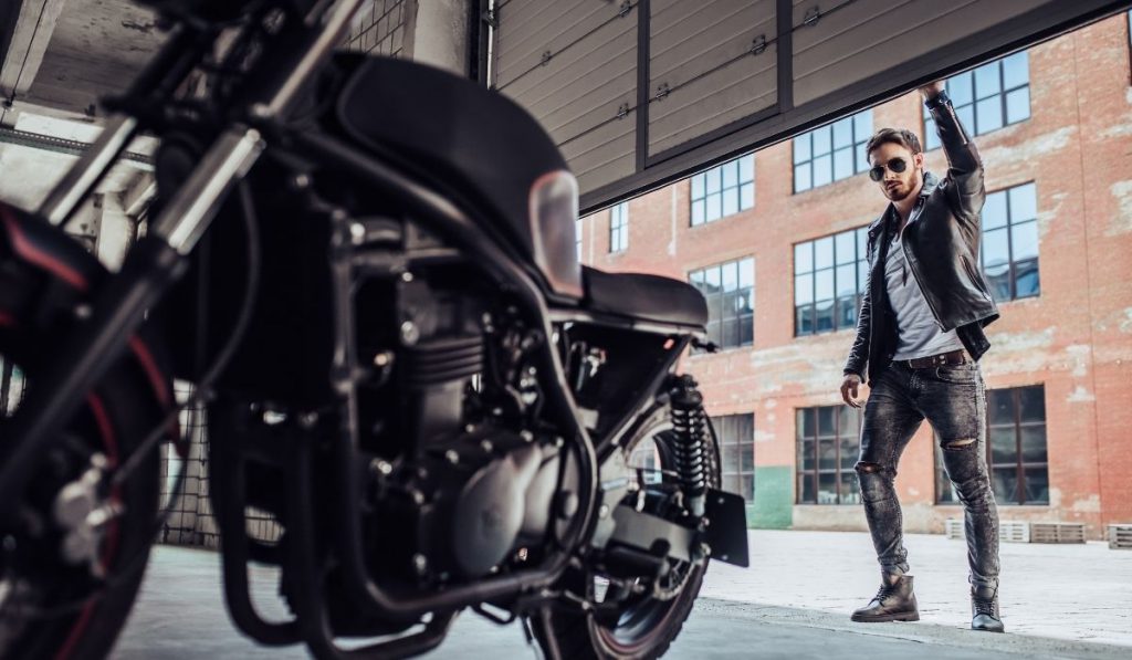 man opening the gate of the  motorcycle storage unit