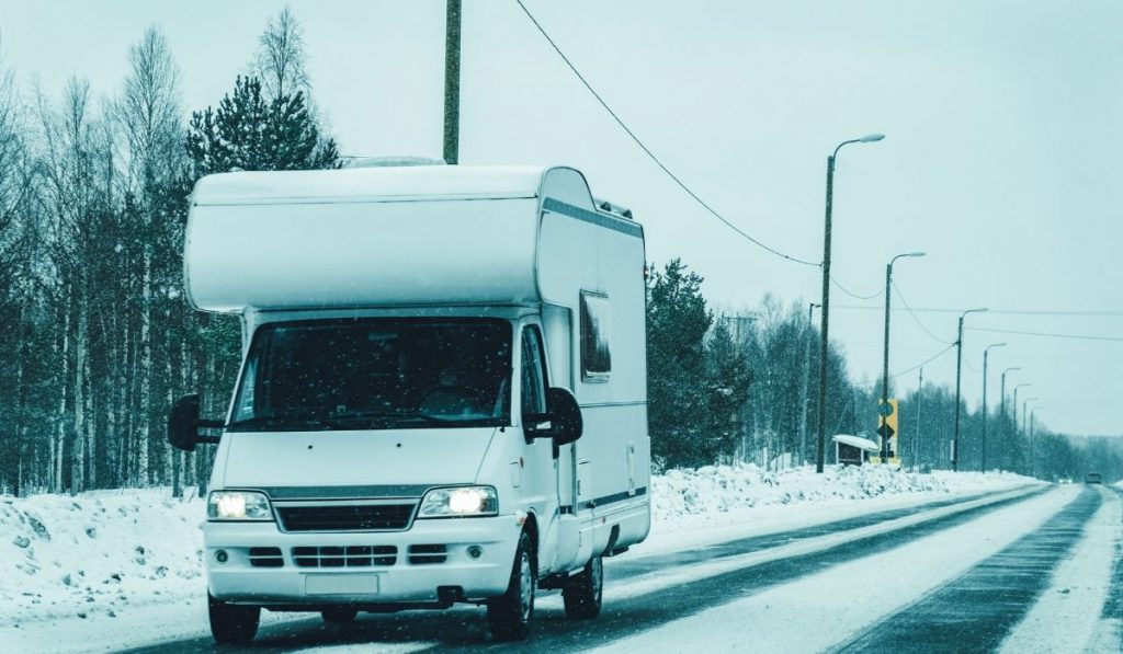 RV on the road with snow