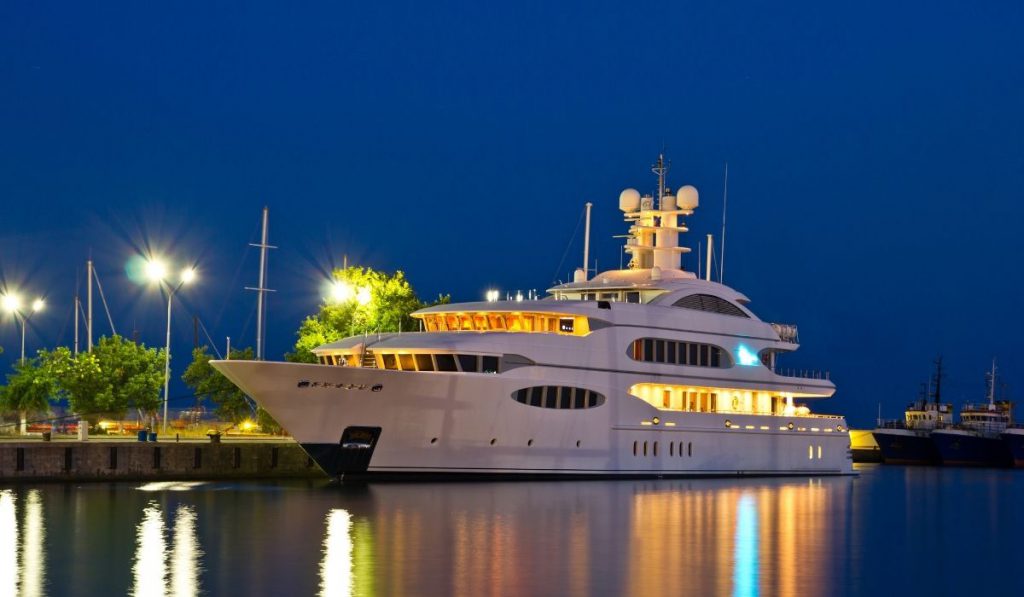 well lit yacht parked at the port